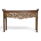 Ornate carved teak console table with floral apron, front view